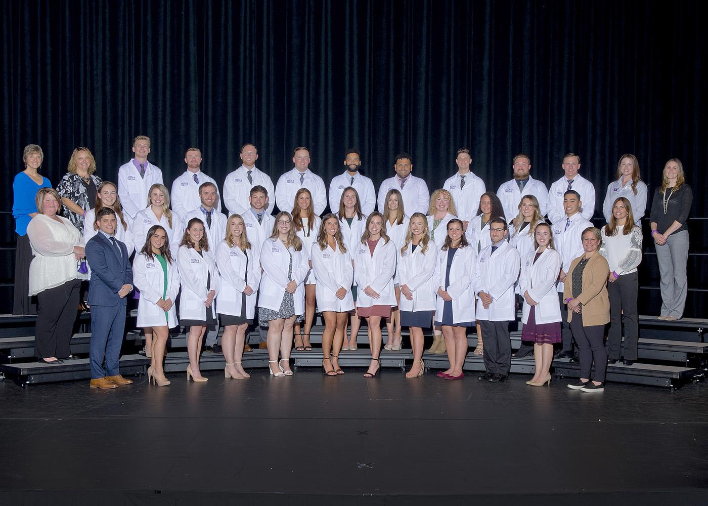The 2021 White Coat Ceremony class standing on stage